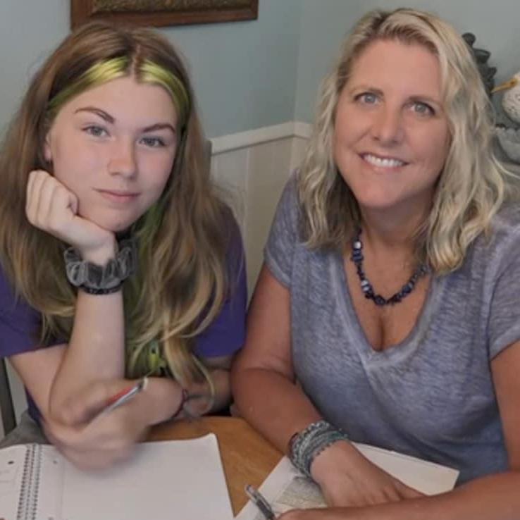 A photo of Ms. Kinney and her daughter smiling after studying for an online class together