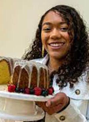 Image of Lilly T, a student at Michigan Connections Academy pictured here holding a bundt cake that she has baked. 