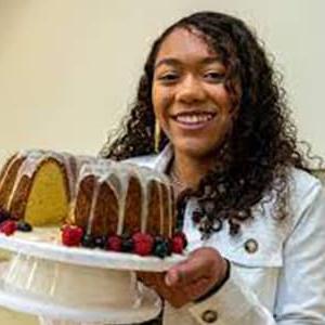 Image of Lilly T, a student at Michigan Connections Academy pictured here holding a bundt cake that she has baked. 