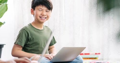 An online school student on a laptop.