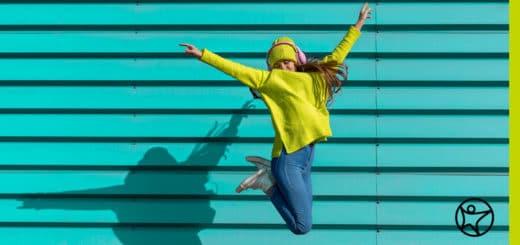 Female student happily jumping in the air - Connections Academy