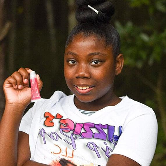 Connections Academy student Kalimah holding up a lip gloss